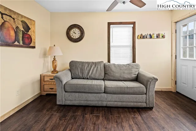 a living room with furniture and a wooden floor