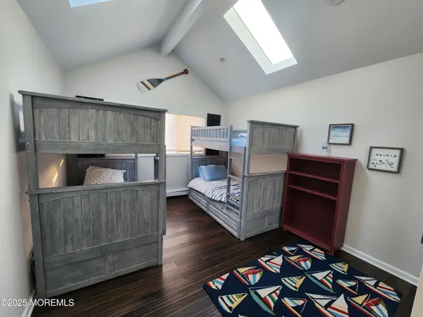 a spacious bathroom with a double vanity sink toilet mirror and bathtub