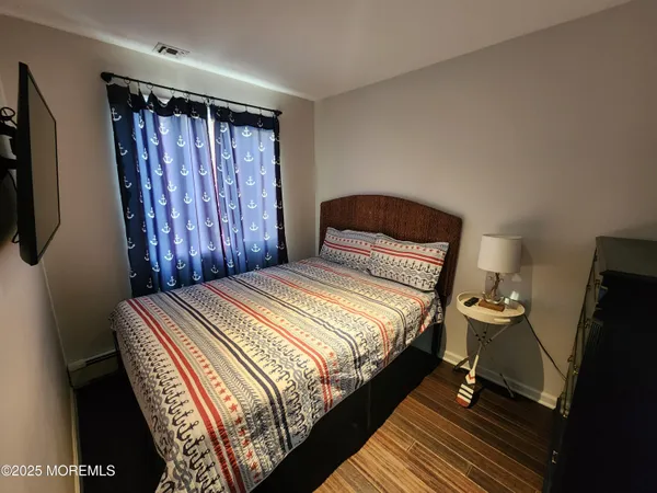 a bedroom with a bed and a television
