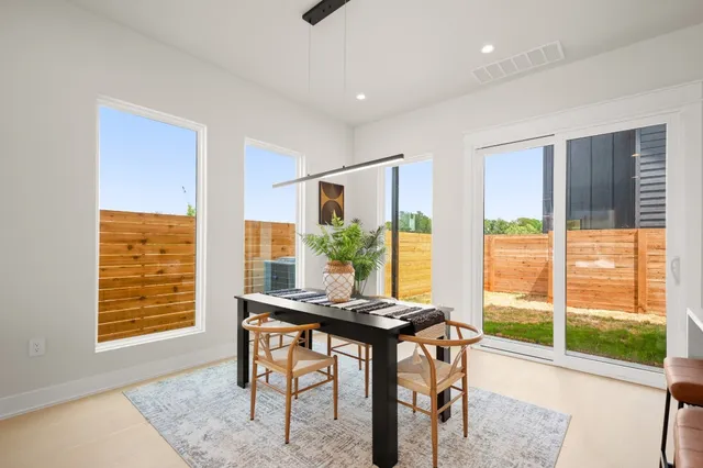 a view of a dining room with furniture and a window