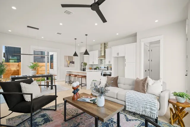 a living room with stainless steel appliances kitchen island granite countertop furniture and a dining table