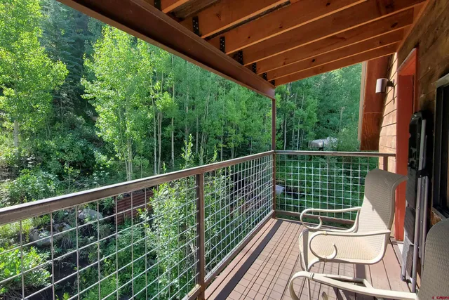 a view of a chair and table in the balcony
