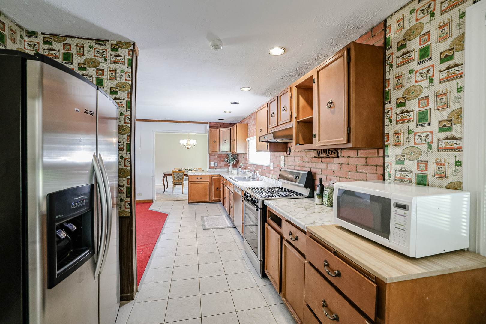 921 Guerin Road Libertyville, IL 60048 - Photo 10 of 43 a large kitchen with stainless steel appliances granite countertop a refrigerator a stove and a sink with wooden floor
