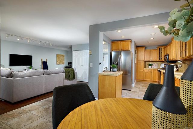 a kitchen with cabinets a sink and stainless steel appliances