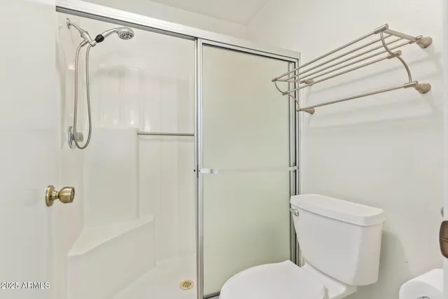a view of an empty room with a ceiling fan