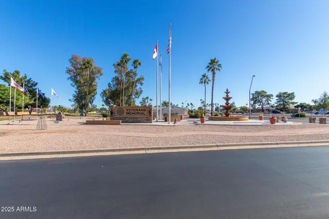 a view of a lake with boats and palm trees