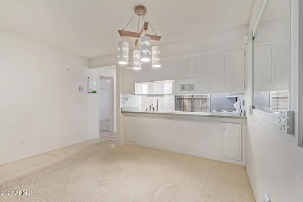 a kitchen with cabinets stainless steel appliances and a sink