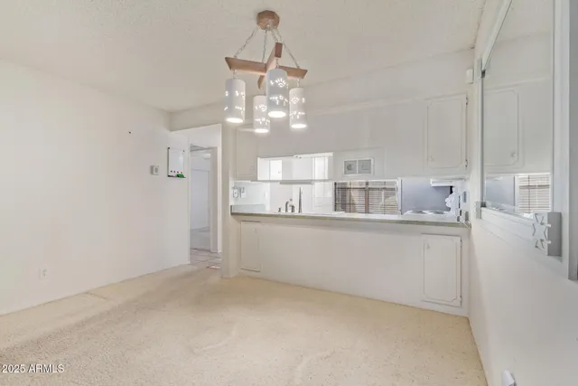 a kitchen with cabinets stainless steel appliances and a sink