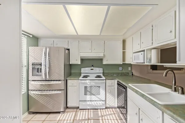 an empty room with a ceiling fan and bathroom