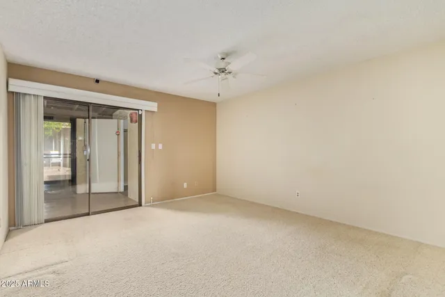 an empty room with fan and a ceiling fan