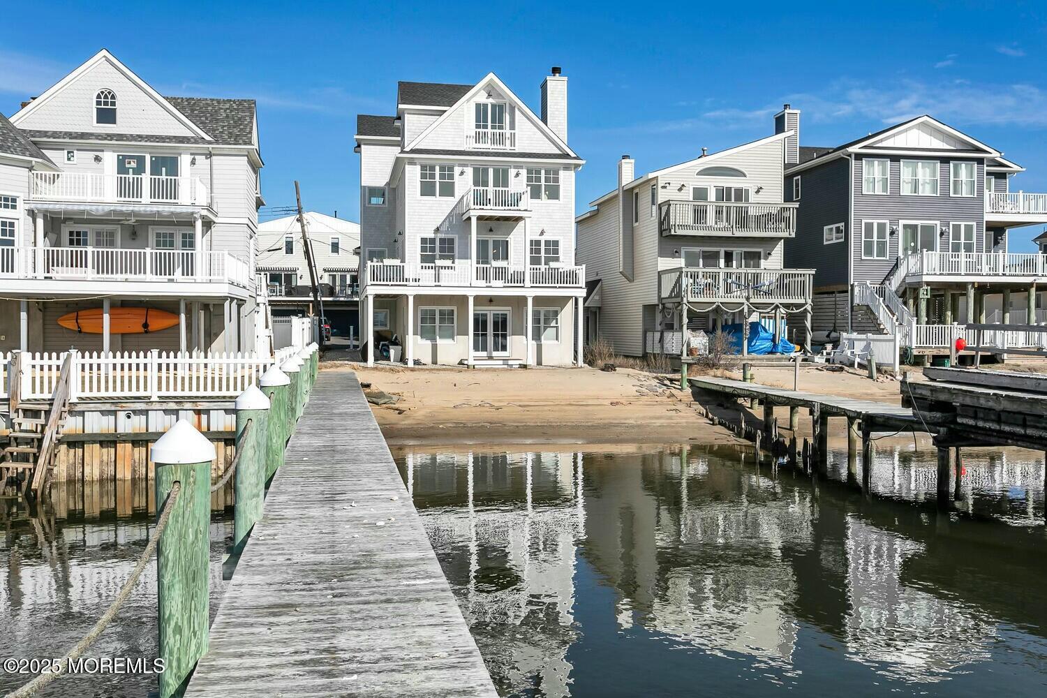 20 Riverview Place Sea Bright, NJ 07760 - Photo 103 of 107 a front view of a residential apartment building with a yard