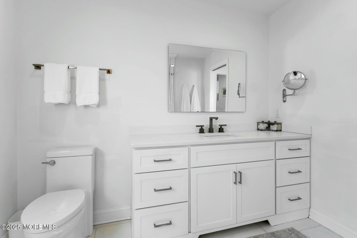 20 Riverview Place Sea Bright, NJ 07760 - Photo 39 of 107 a bathroom with a toilet a sink a mirror and vanity