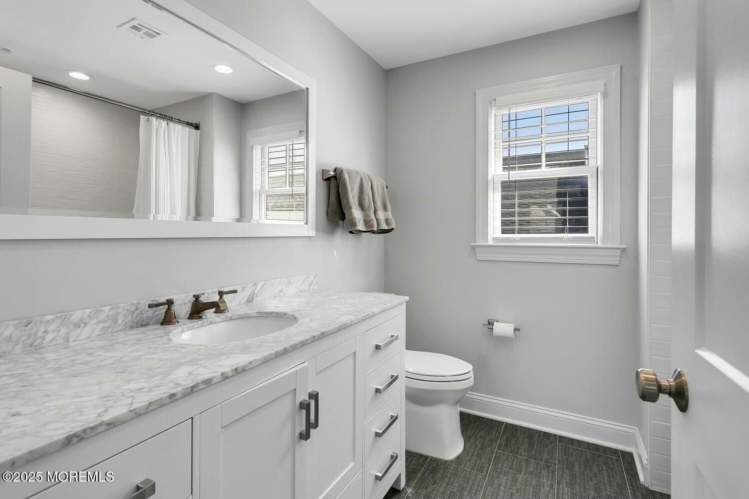20 Riverview Place Sea Bright, NJ 07760 - Photo 45 of 107 a bathroom with a granite countertop sink a toilet and a mirror