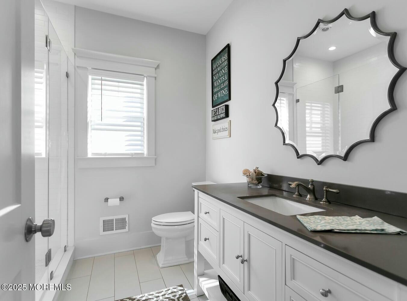 20 Riverview Place Sea Bright, NJ 07760 - Photo 46 of 107 a bathroom with a granite countertop sink a toilet and a mirror