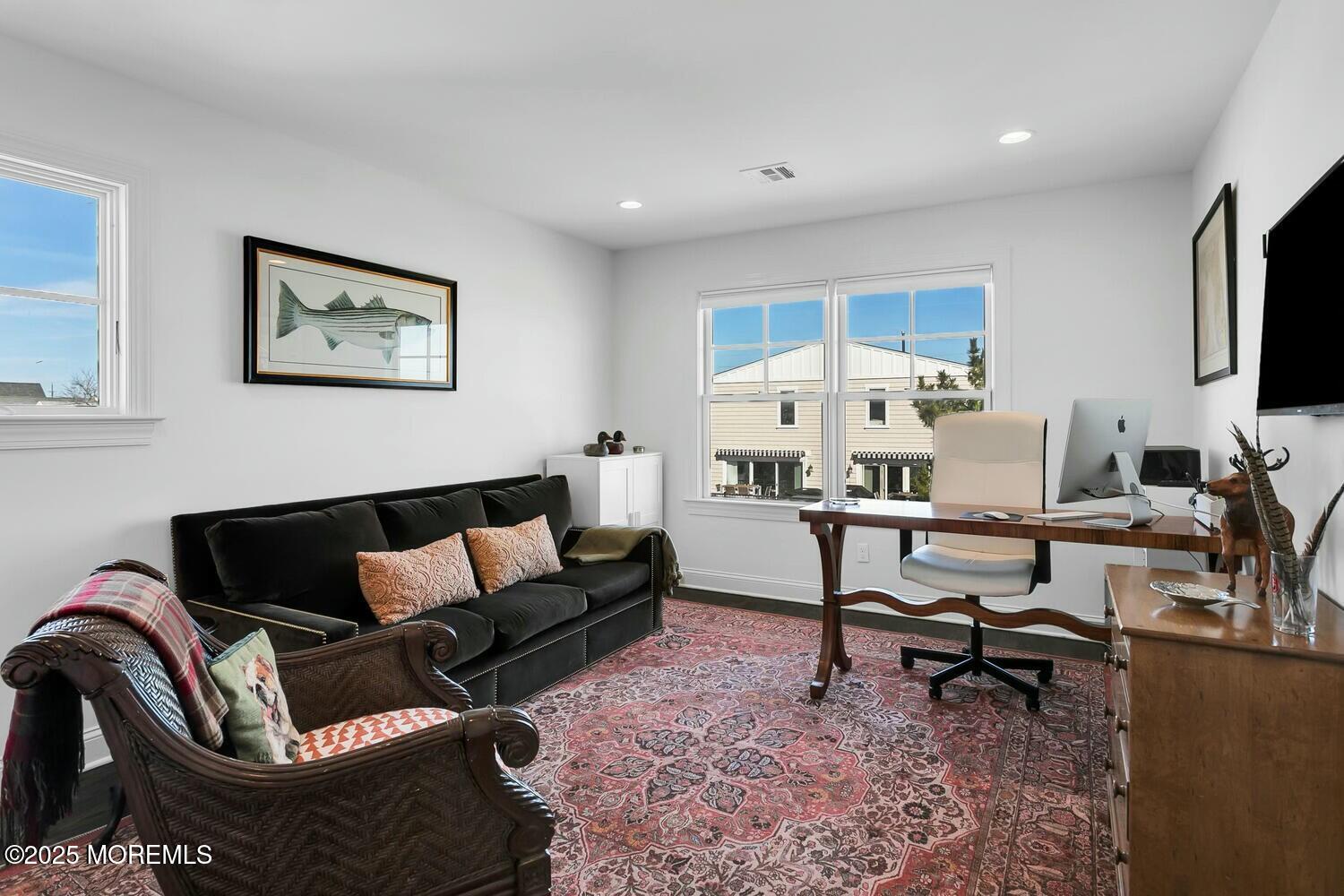 20 Riverview Place Sea Bright, NJ 07760 - Photo 49 of 107 a living room with furniture a rug and a flat screen tv