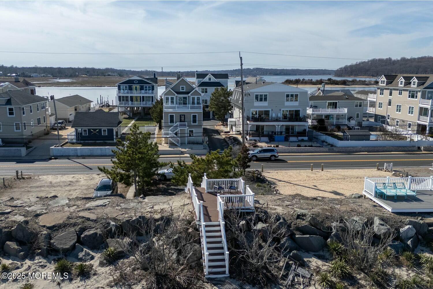 20 Riverview Place Sea Bright, NJ 07760 - Photo 84 of 107 a view of a lake with a building and trees in front of it