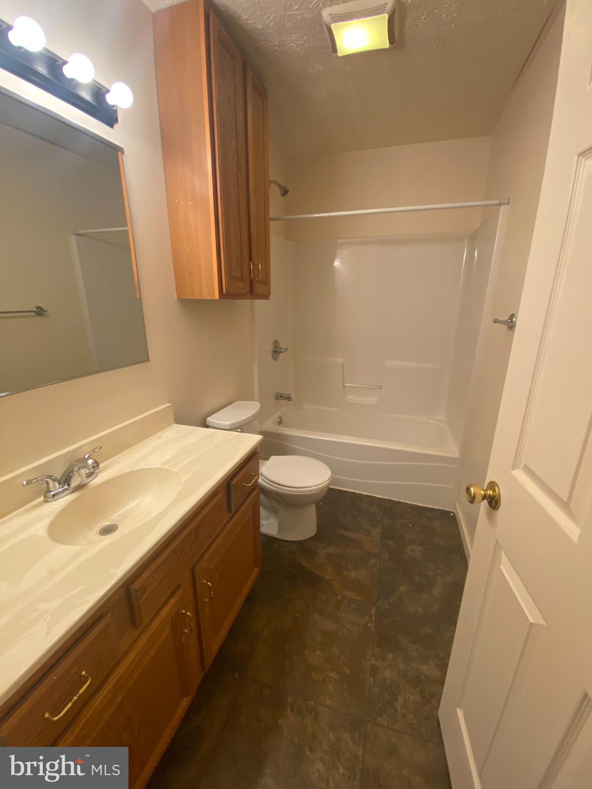 28 Holler Road, Unit 3 Keyser, WV 26726 - Photo 17 of 23 a bathroom with a sink a toilet and shower