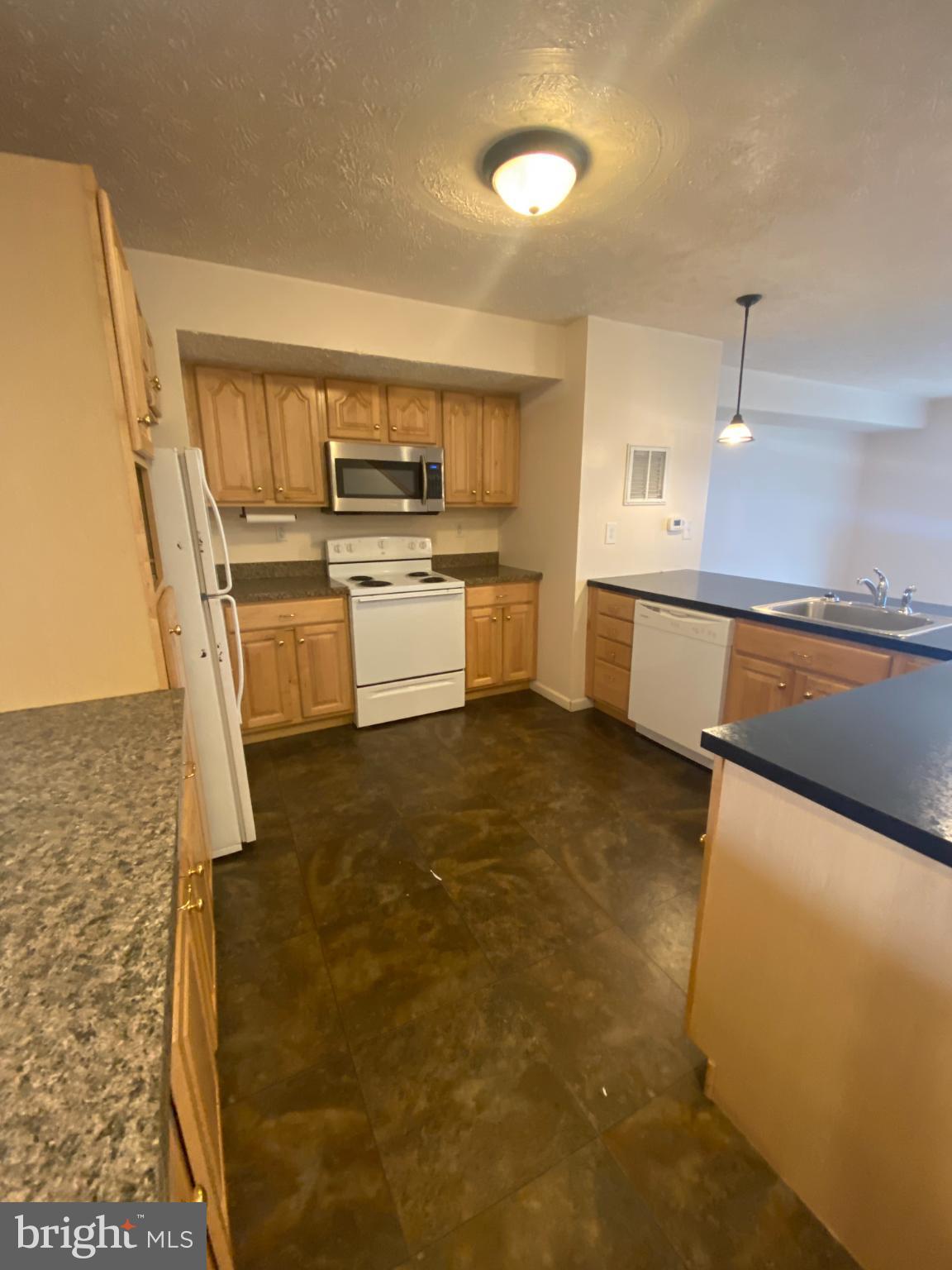 28 Holler Road, Unit 3 Keyser, WV 26726 - Photo 2 of 23 a large white kitchen with sink and stainless steel appliances