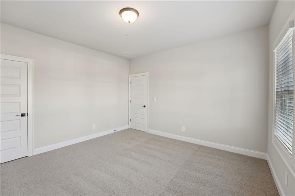 6440 Pinin Place Cumming, GA 30041 - Photo 32 of 52 an empty room with a window