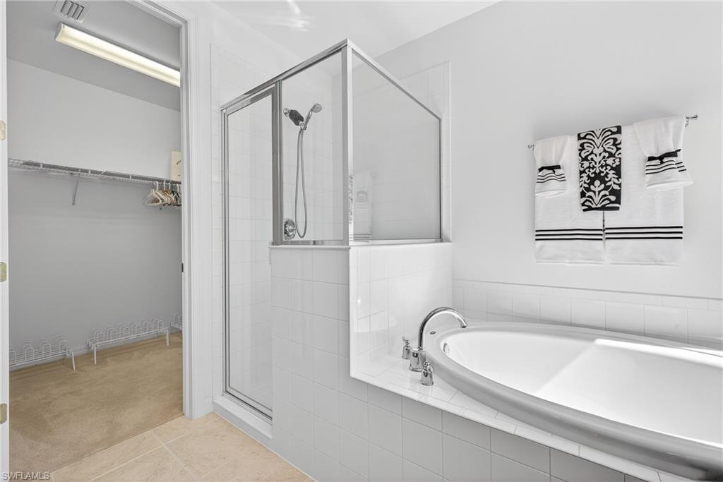 1248 Manado Drive Naples, FL 34113 - Photo 20 of 45 a bathroom with a tub a sink and a shower