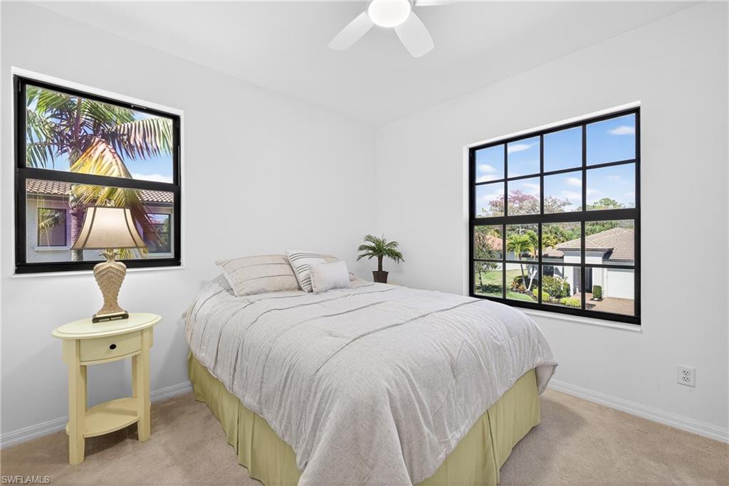 1248 Manado Drive Naples, FL 34113 - Photo 21 of 45 a bedroom with a large bed and a window