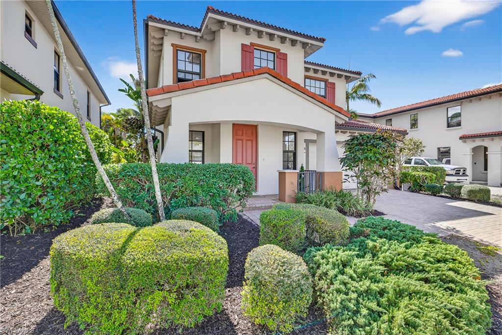 1248 Manado Drive Naples, FL 34113 - Photo 3 of 45 a front view of a house with garden