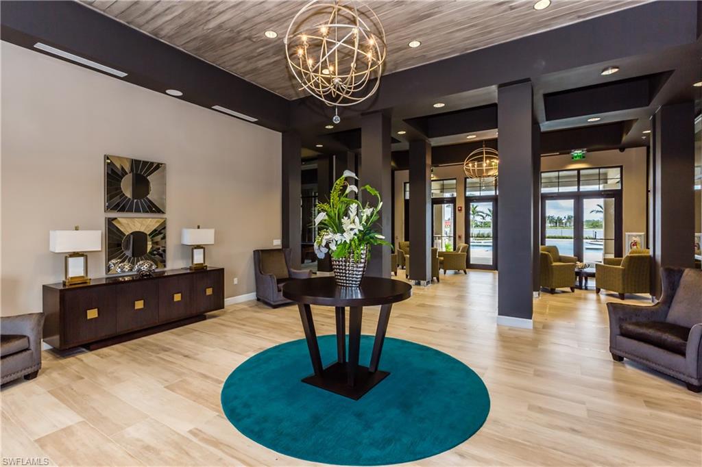 1248 Manado Drive Naples, FL 34113 - Photo 34 of 45 a living room with fireplace furniture and a chandelier