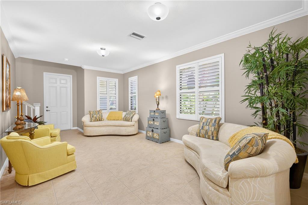 1248 Manado Drive Naples, FL 34113 - Photo 5 of 45 a living room with furniture and a large window