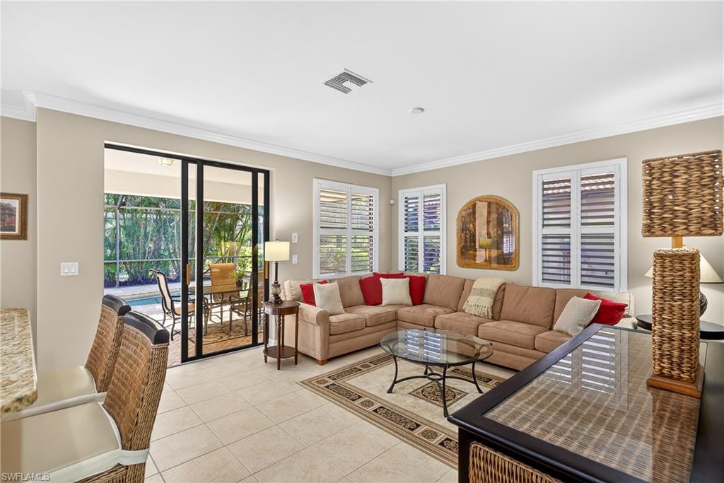 1248 Manado Drive Naples, FL 34113 - Photo 7 of 45 a living room with furniture and a large window