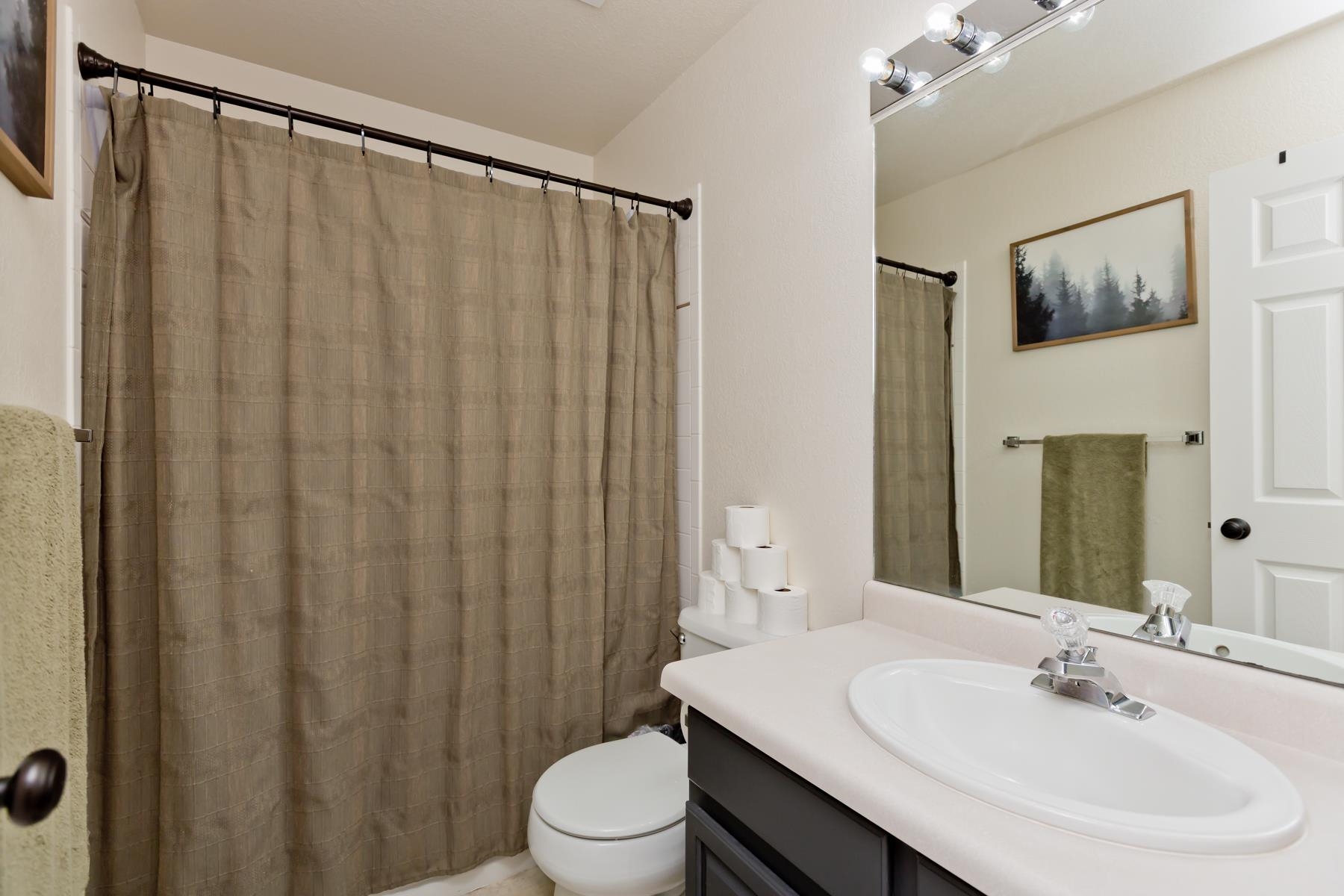 528 Park Ridge Court Grand Junction, CO 81507 - Photo 22 of 42 a bathroom with a sink a toilet and shower curtain