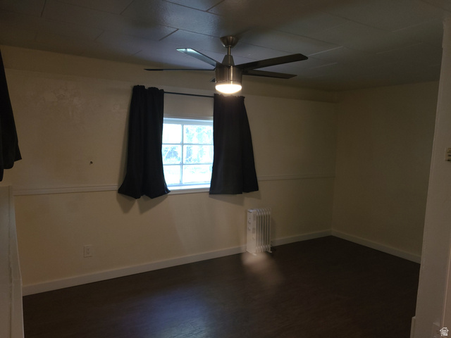 684 East 400 North Logan, UT 84321 - Photo 16 of 27 Room featuring dark wood-finish flooring, a ceiling fan with integrated lighting, and a white-framed window