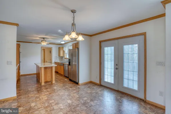 a spacious bathroom with a granite countertop sink and a mirror