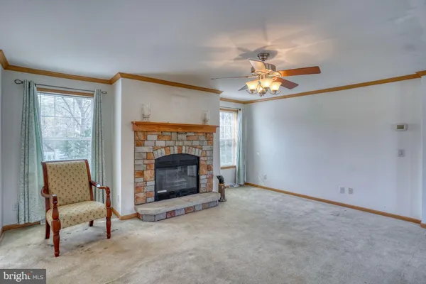 a view of a livingroom with a fireplace and window