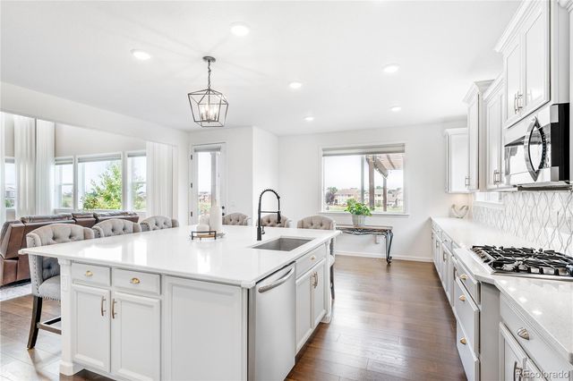 a kitchen with sink stove and cabinets