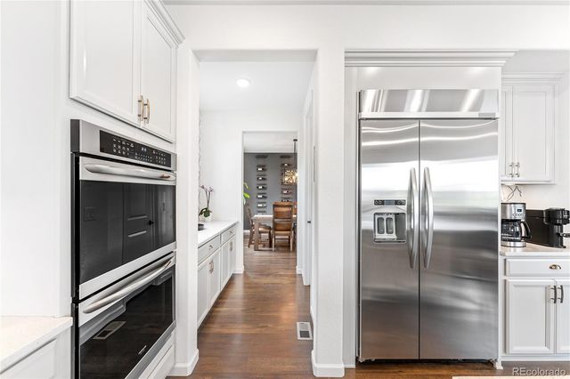a kitchen with a refrigerator and a oven