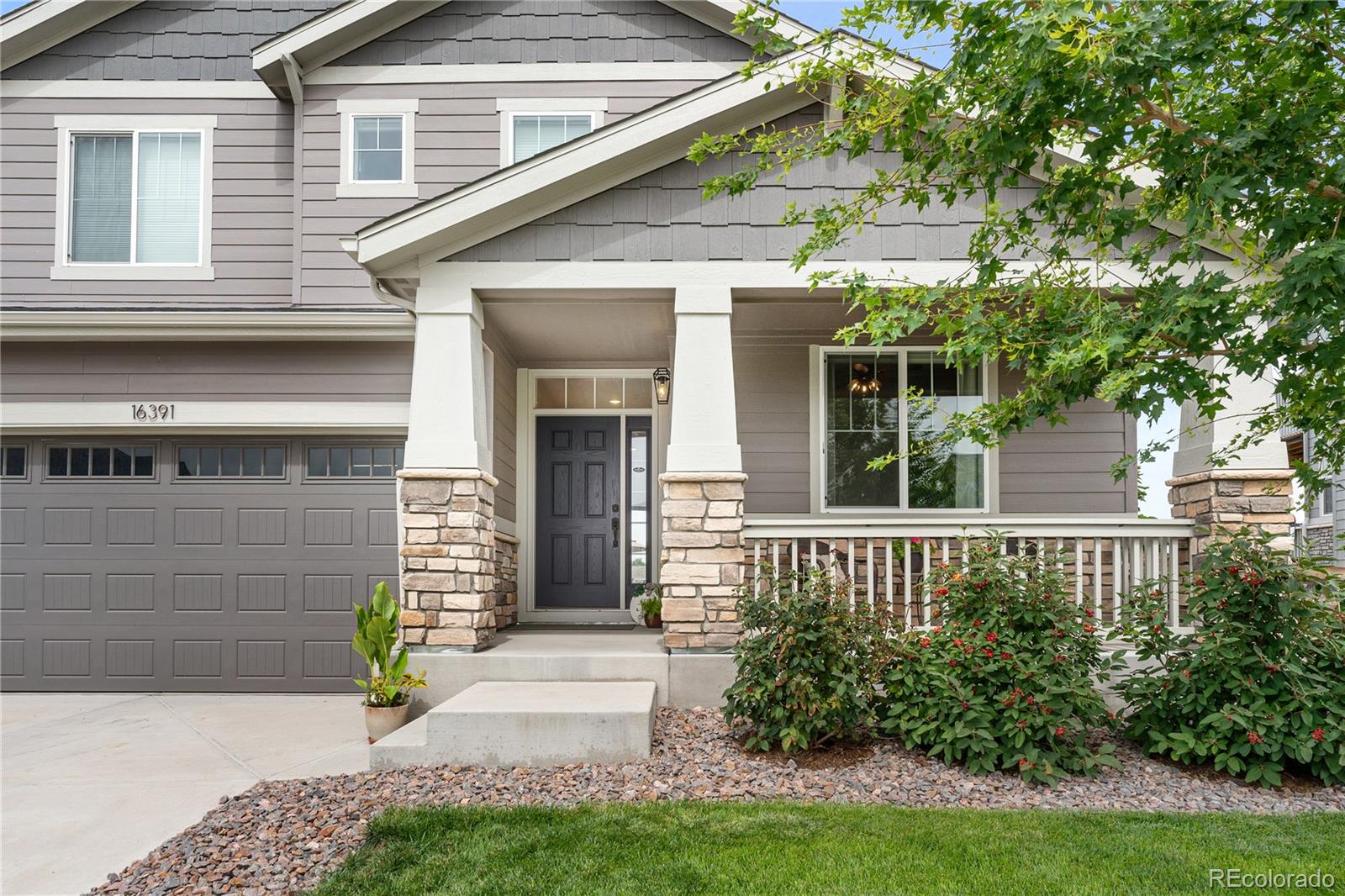 16391 Buffalo Run Drive Commerce City, CO 80022 - Photo 2 of 49 a front view of a house with garden