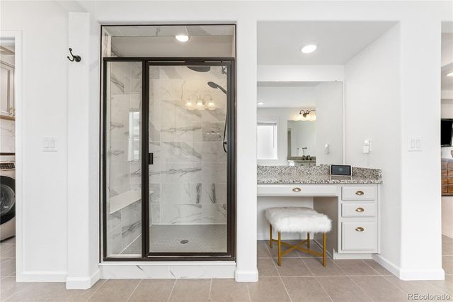 a bathroom with a shower a mirror and a sink