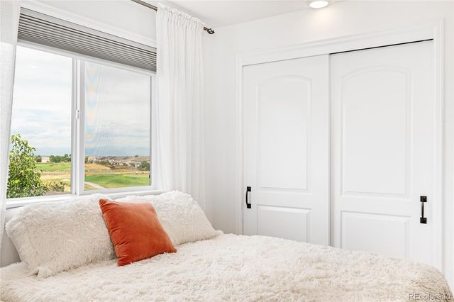 a bedroom with a large bed and a large window