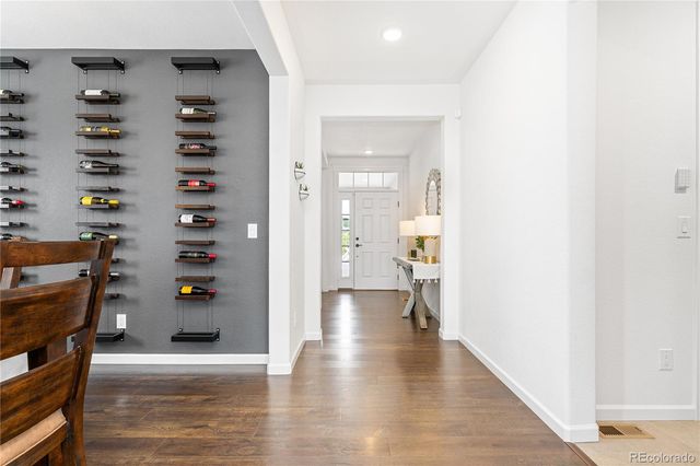 a view of a hallway view with wooden floor and windows