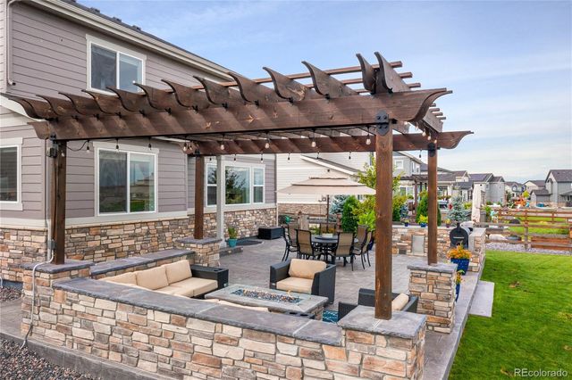 a view of a patio with table and chairs and potted plants