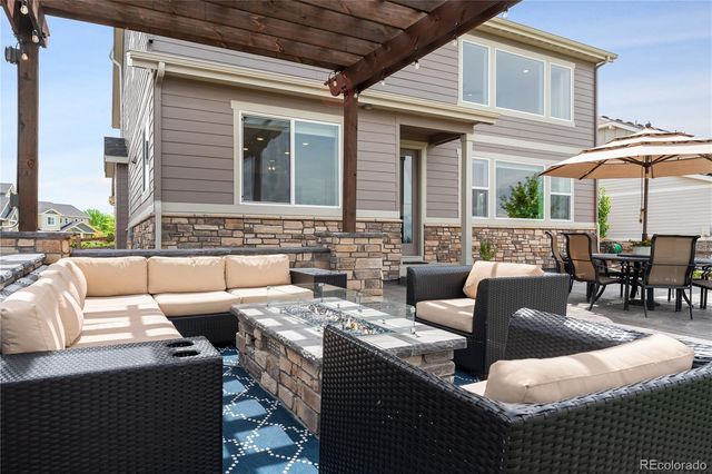 a view of a patio with couches chairs and potted plants