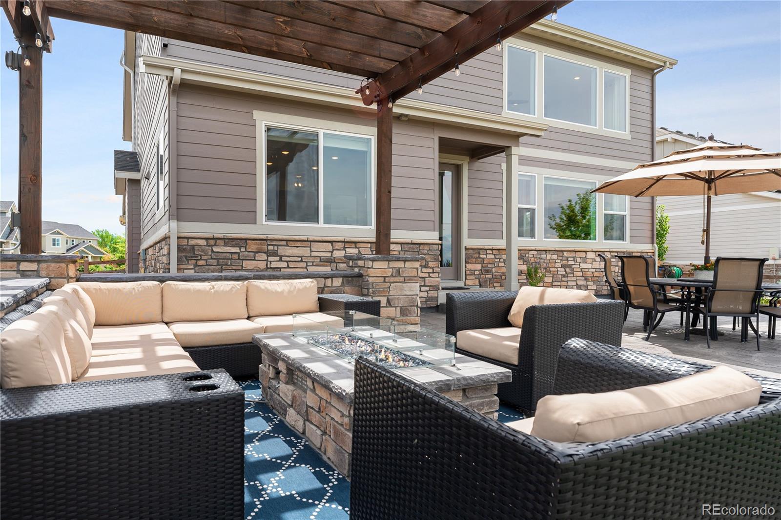 16391 Buffalo Run Drive Commerce City, CO 80022 - Photo 40 of 49 a view of a patio with couches chairs and potted plants