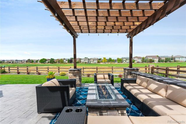 a view of a patio with couches chairs and city view