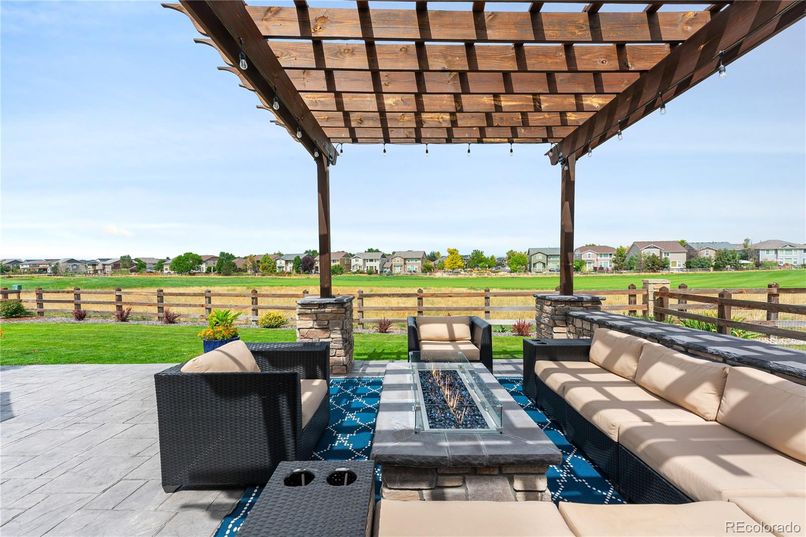 16391 Buffalo Run Drive Commerce City, CO 80022 - Photo 41 of 49 a view of a patio with couches chairs and city view