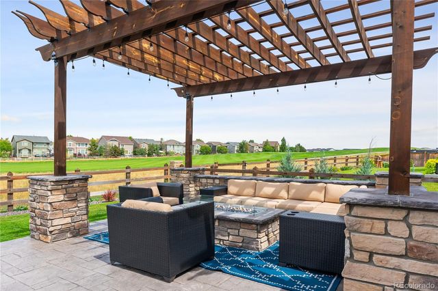 a view of an outdoor living space with furniture and garden view