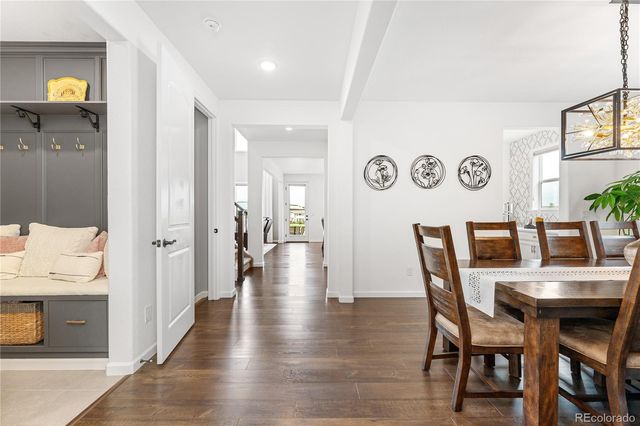 a dining room with furniture and wooden floor