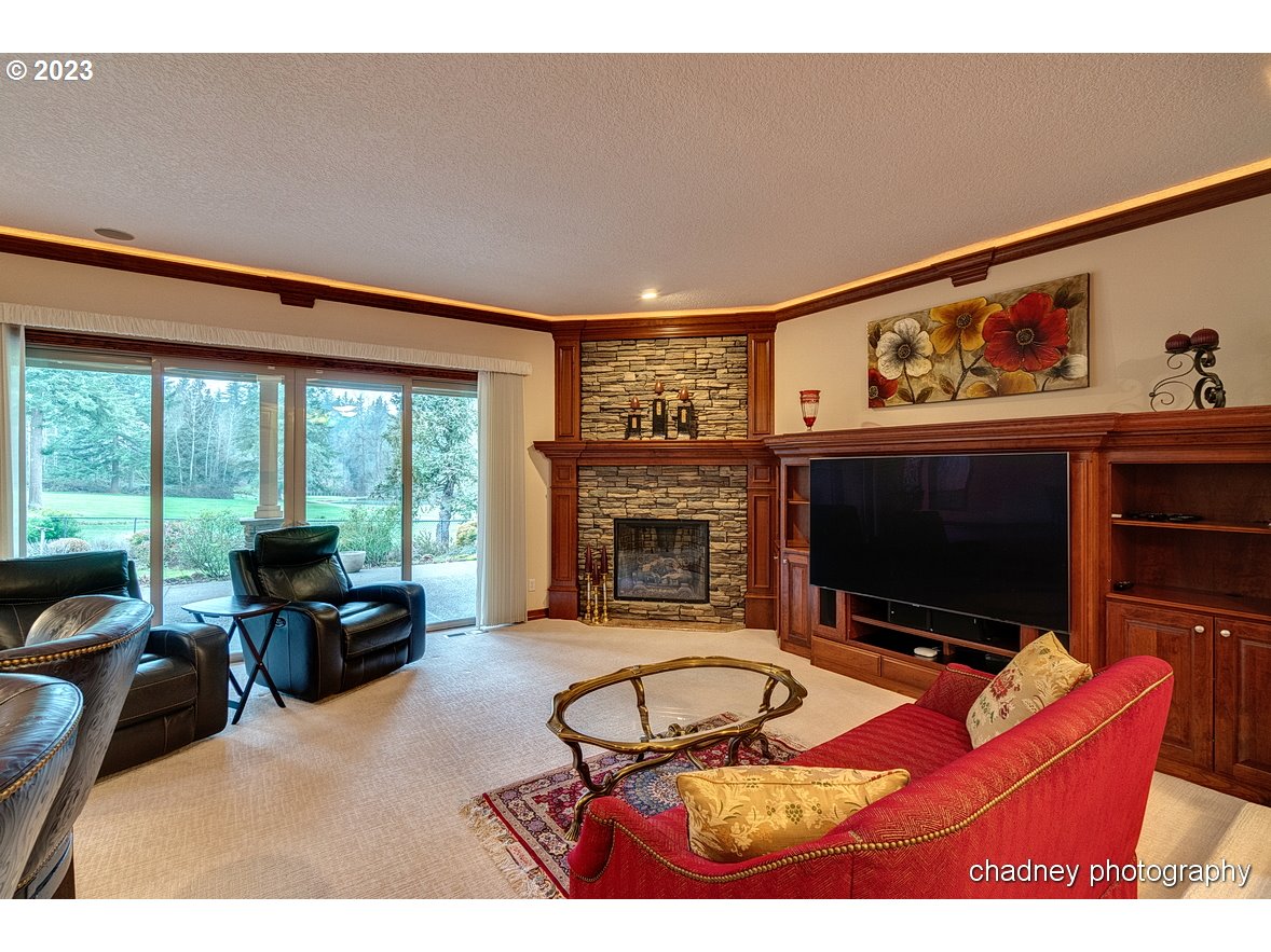 13507 Southeast Richey Road Boring, OR 97009 - Photo 6 of 34 a living room with furniture a flat screen tv and a fireplace