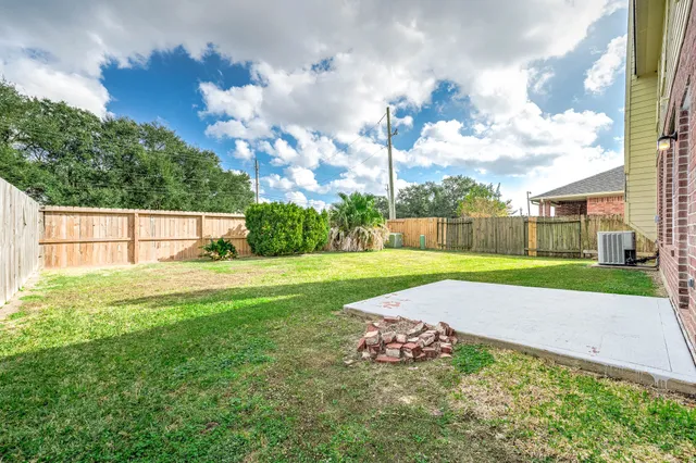 a front view of house with backyard and green space