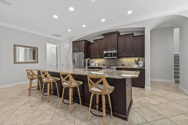 a kitchen with granite countertop a sink stove and cabinets