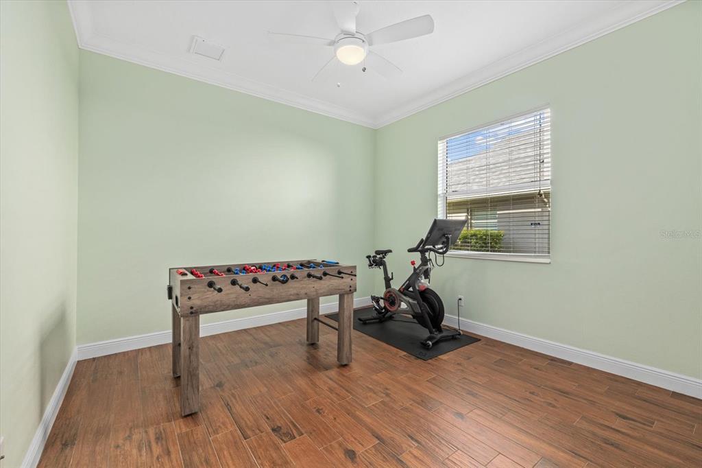 4727 Balboa Park Loop Bradenton, FL 34211 - Photo 30 of 56 a view of a room with wooden floor gym equipment and windows